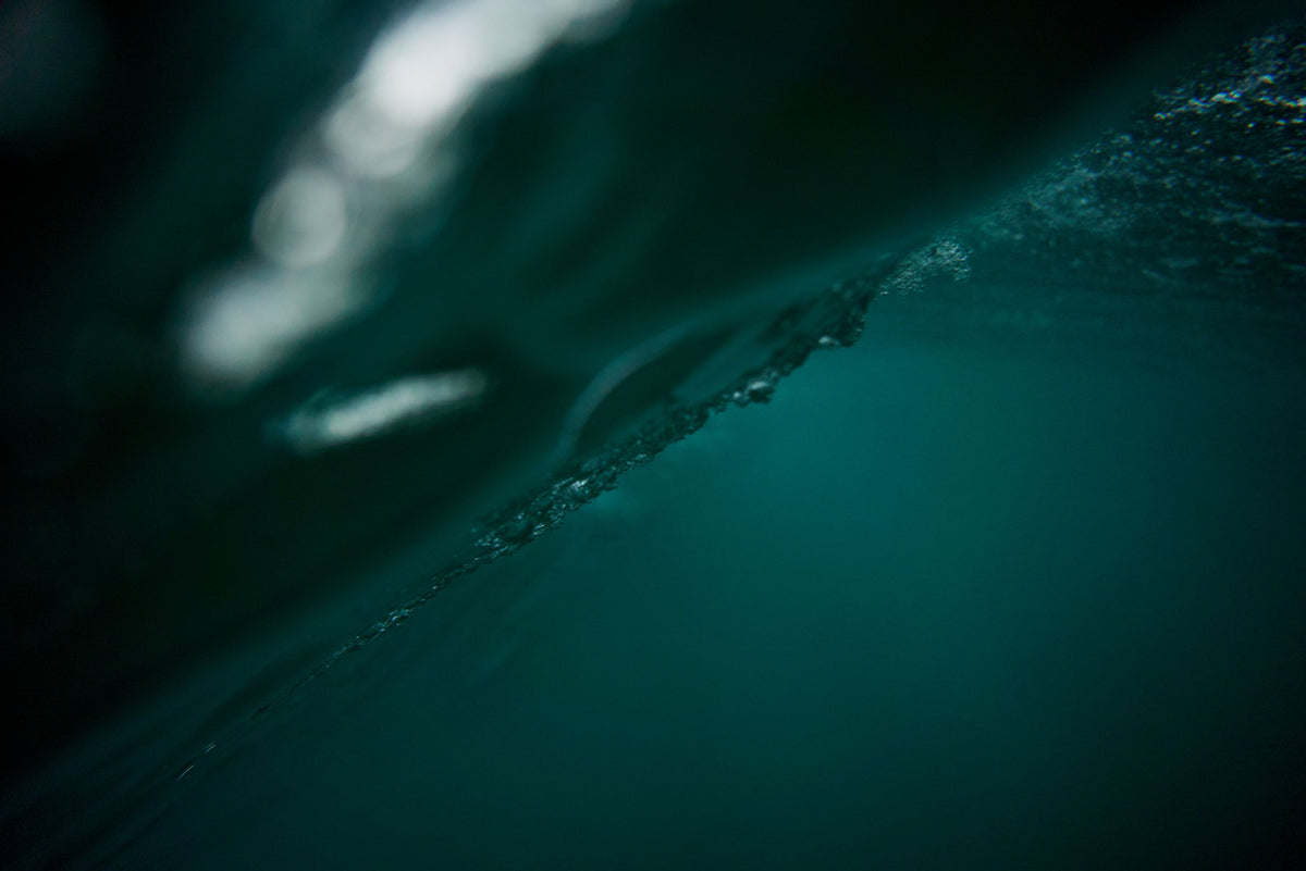 Inside a breaking wave, deep green water